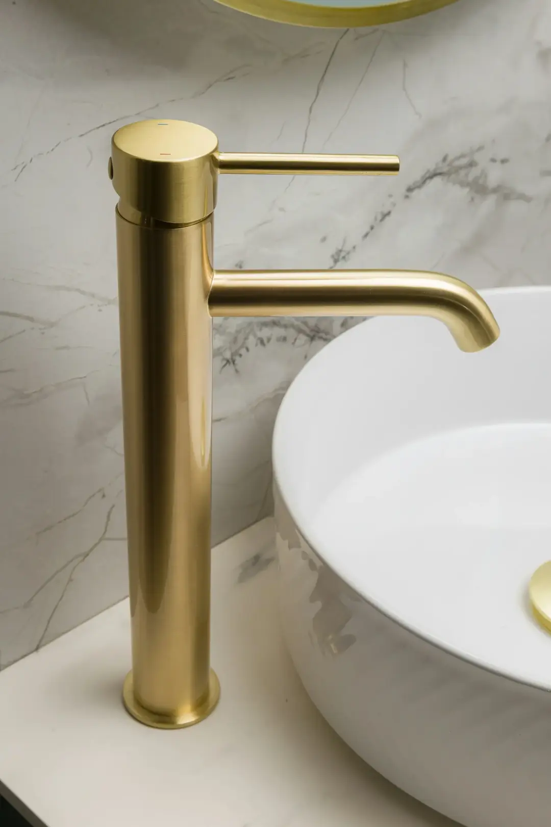 Brass mixer tap beside a bathroom basin
