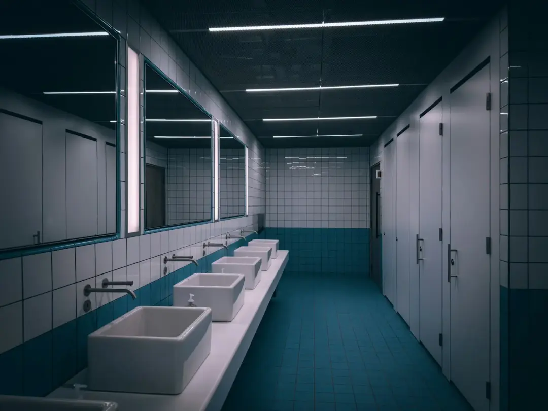 Rows of basins and cubicles in a London public washroom
